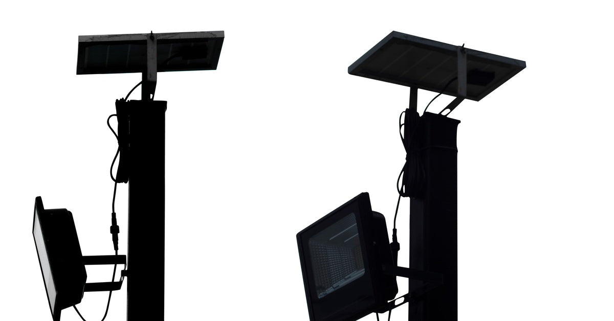 The silhouettes of two solar spotlights sit against a white background. Both the lights' panels lay flat.